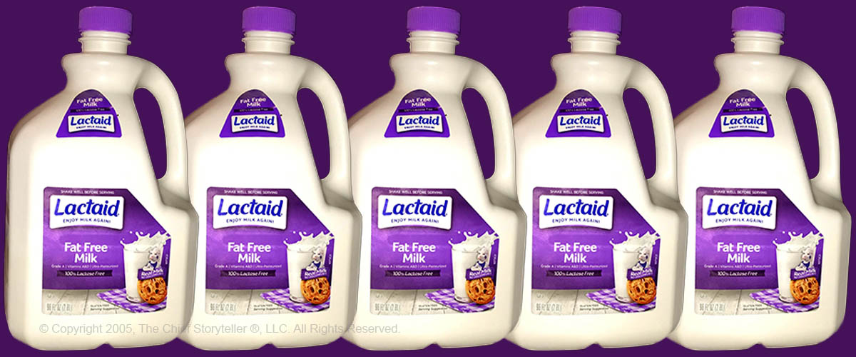 five milk cartons, size by side with small overlap, Lactaid fat free, purple top and background, talk fat free