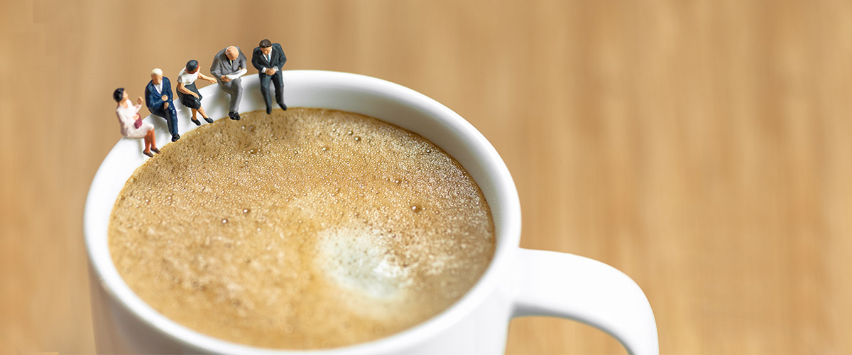 coffee cup with miniature people sitting on rim, metaphor for this guest post about ordering a cup of coffee when meeting with customers