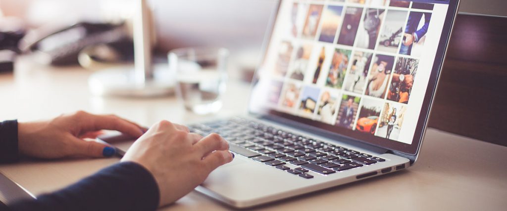 woman executive using laptop, hands visible on keyboard with laptop open - emarketing relevancy