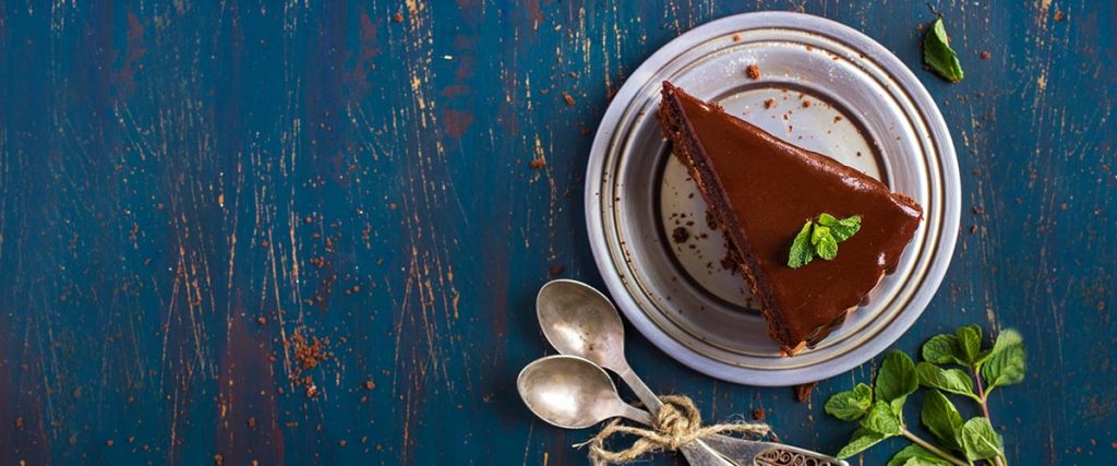 delicious, scrumptious looking slice of chocolate cake with mint leaves for dessert