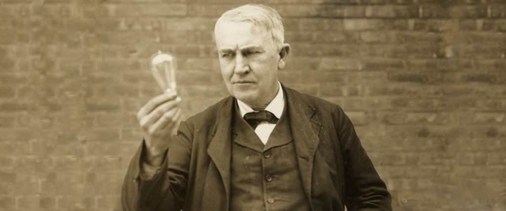 thomas alva edison circa 1910, holding lightbulb up in his right hand