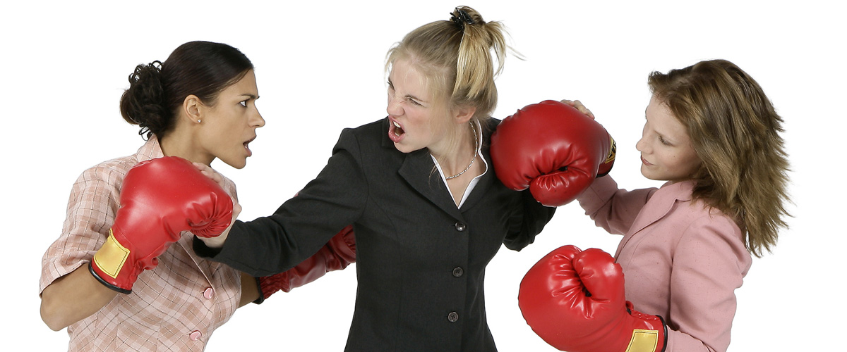 two female executives fiercly boxing, both in business suits, with obvious facial expressions of anger - serves as a metaphor on how to persuade