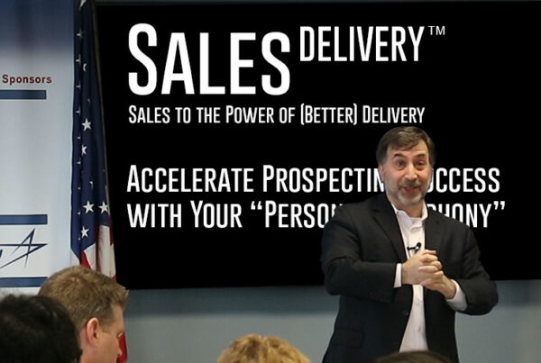 ira koretsky speaking at the MCCC, delivering his Sales to the Power of Delivery hands-on program. Ira is in a suit, no jacket, engaging the audience about their sales stories