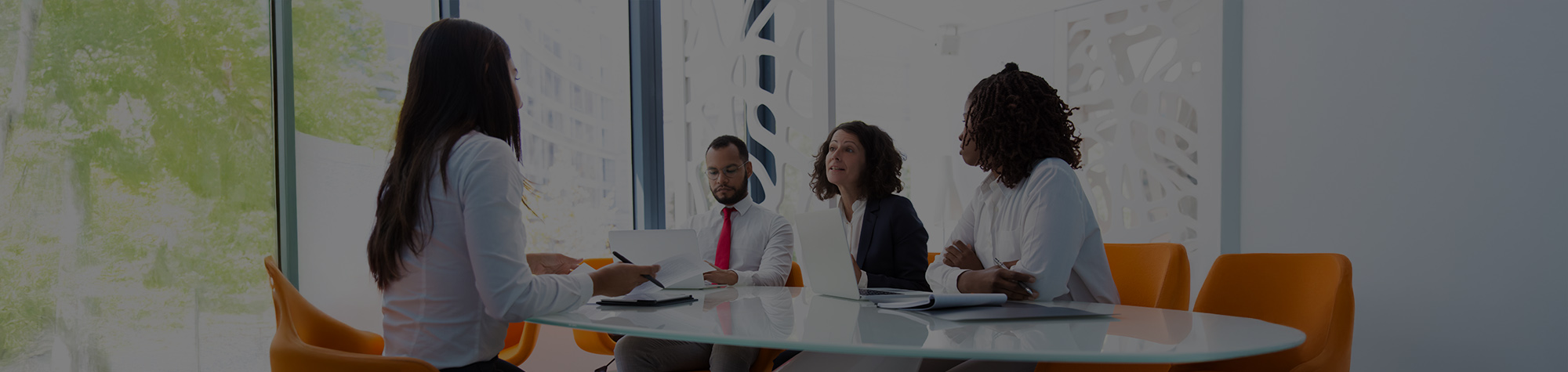 group of three executives interviewing a candidate
