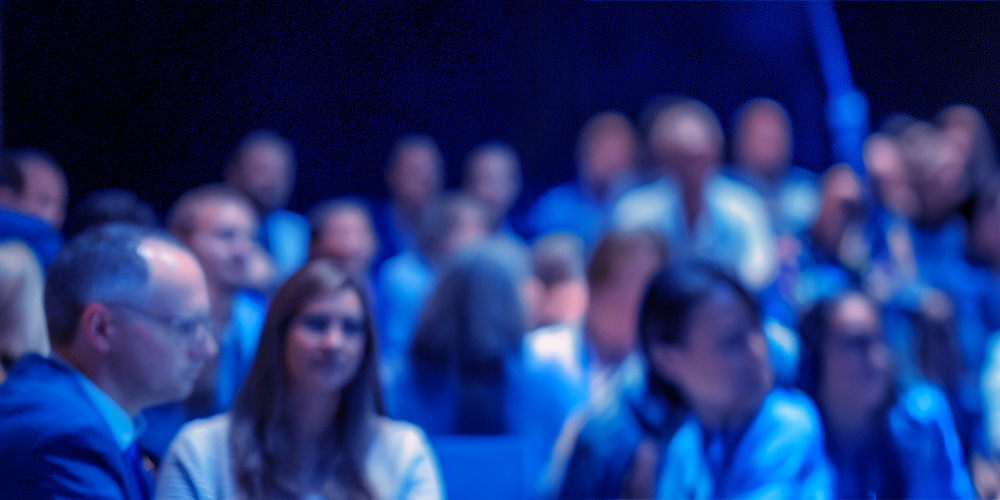 M&A communication coaching services showing three part image of male executive founder speaking to investors, this is the left.